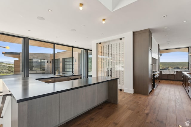 7455 N Promontory Ranch Rd, Park City, UT 84098 - kitchen with a sink, expansive windows, dark wood-style floors, and dark brown cabinets