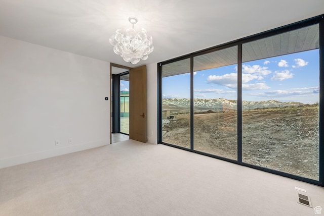 7455 N Promontory Ranch Rd, Park City, UT 84098 - spare room with a wall of windows, a chandelier, carpet floors, and a mountain view