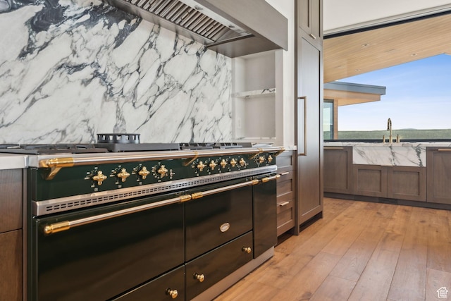7455 N Promontory Ranch Rd, Park City, UT 84098 - kitchen with a sink, range with two ovens, light wood-style flooring, and backsplash