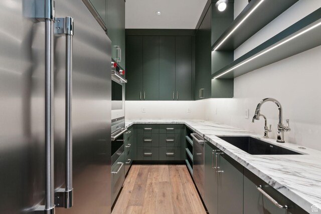 7455 N Promontory Ranch Rd, Park City, UT 84098 - kitchen featuring appliances with stainless steel finishes, a sink, light stone countertops, light wood-type flooring, and open shelves