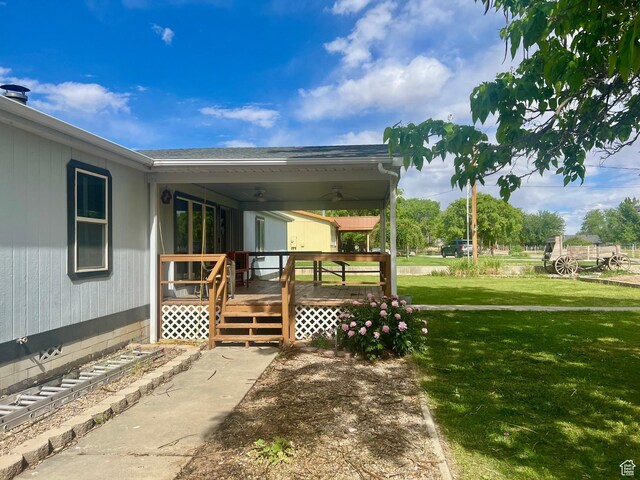 465 E Kings Ln, Green River, UT 84525 - exterior space featuring ceiling fan, a lawn, and a wooden deck