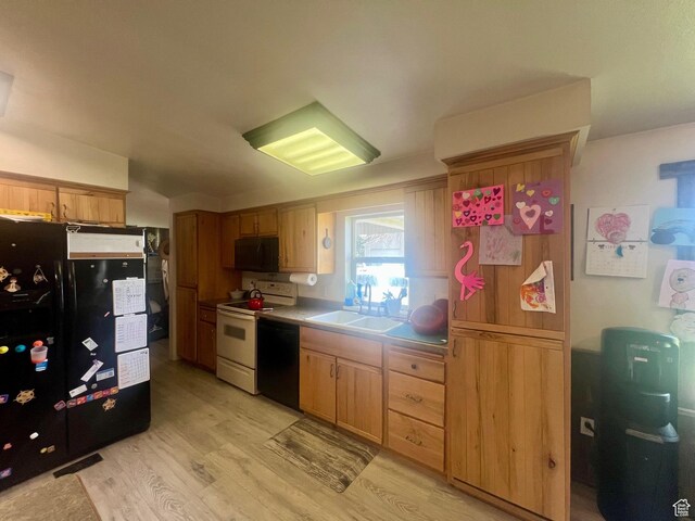 465 E Kings Ln, Green River, UT 84525 - kitchen featuring black appliances, a sink, light wood-style flooring, and light countertops