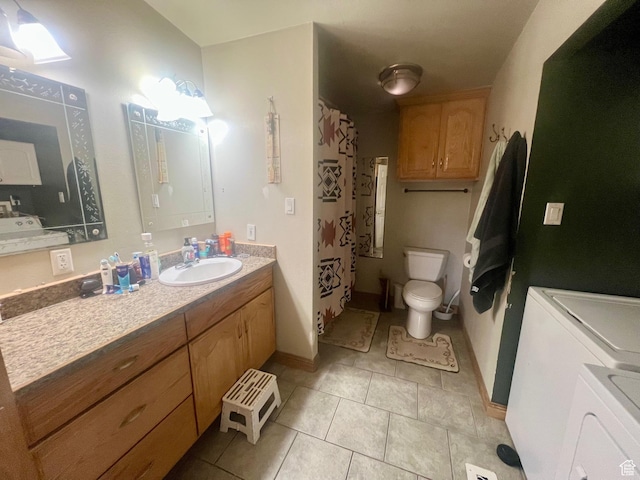 465 E Kings Ln, Green River, UT 84525 - bathroom with separate washer and dryer, toilet, tile patterned flooring, vanity, and baseboards