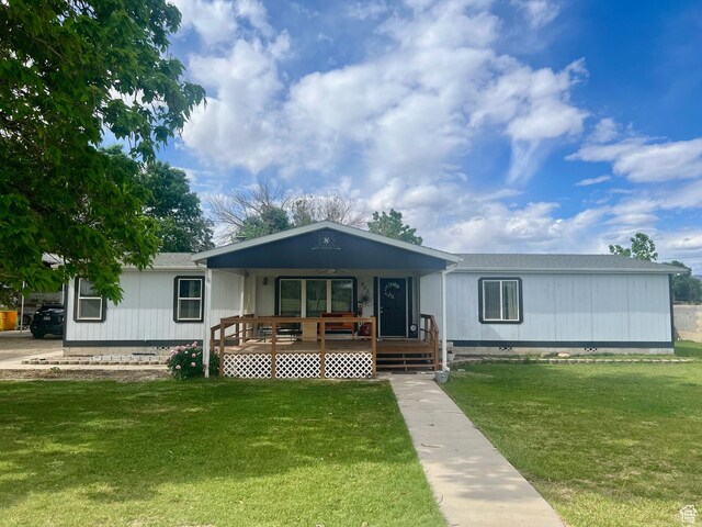 465 E Kings Ln, Green River, UT 84525 - manufactured / mobile home with a porch, a front lawn, and crawl space