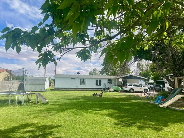 465 E Kings Ln, Green River, UT 84525 - view of grassy yard featuring a trampoline