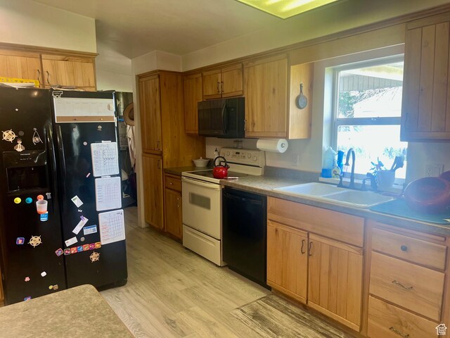 465 E Kings Ln, Green River, UT 84525 - kitchen with black appliances, a sink, light wood-style flooring, and light countertops