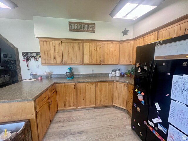 465 E Kings Ln, Green River, UT 84525 - kitchen featuring black refrigerator with ice dispenser, a peninsula, light wood-style floors, and dark countertops