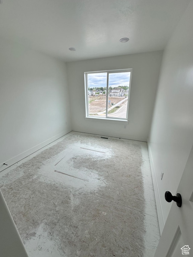 unfurnished room featuring baseboards
