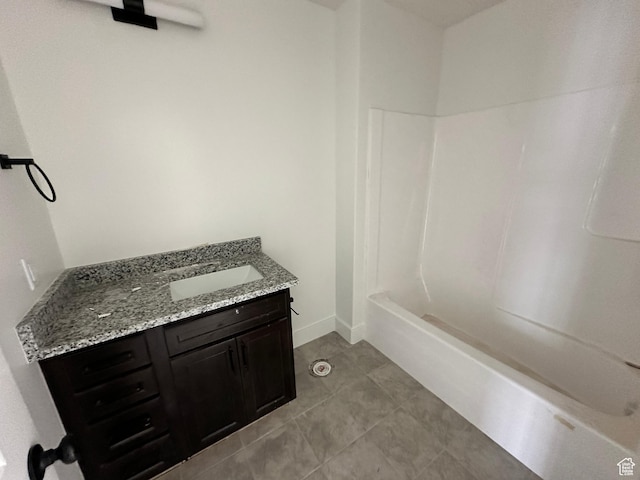 full bath featuring vanity, tile patterned flooring, tub / shower combination, and baseboards