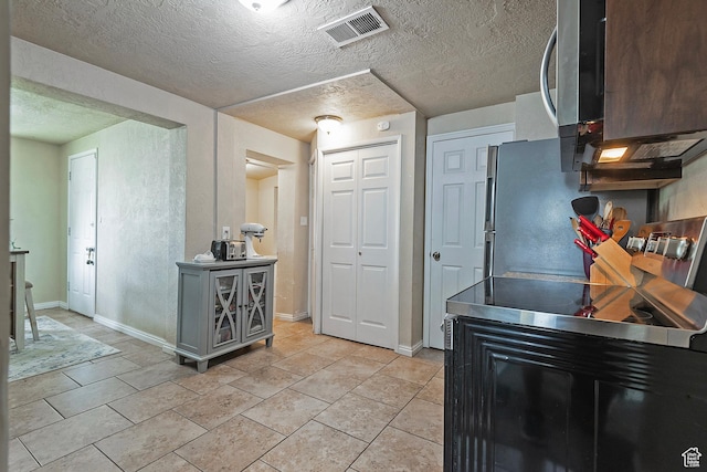 1154 S Montgomery St W, Salt Lake City, UT 84104 - kitchen with stainless steel appliances, baseboards, a textured ceiling, and light tile patterned flooring