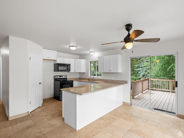 kitchen featuring black appliances, a peninsula, a ceiling fan, white cabinets, and a sink