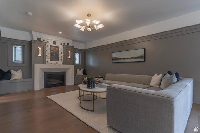 158 N State St, Salt Lake City, UT 84103 - living area with a chandelier, wood finished floors, a glass covered fireplace, and healthy amount of natural light