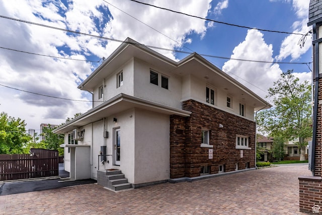 158 N State St, Salt Lake City, UT 84103 - view of home's exterior with stucco siding and fence