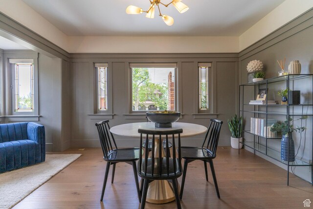 158 N State St, Salt Lake City, UT 84103 - dining space with a chandelier, wood finished floors, and a decorative wall