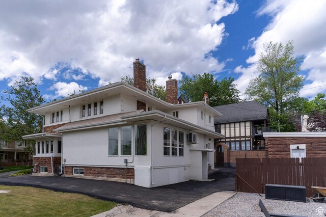 158 N State St, Salt Lake City, UT 84103 - back of property with stucco siding, a chimney, and fence