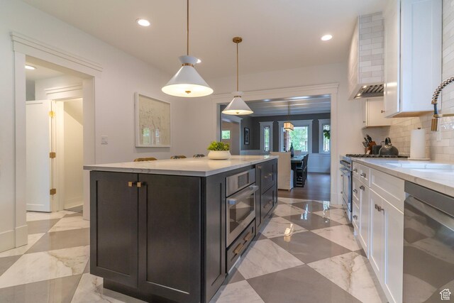 158 N State St, Salt Lake City, UT 84103 - kitchen with stainless steel appliances, white cabinetry, backsplash, recessed lighting, and a center island
