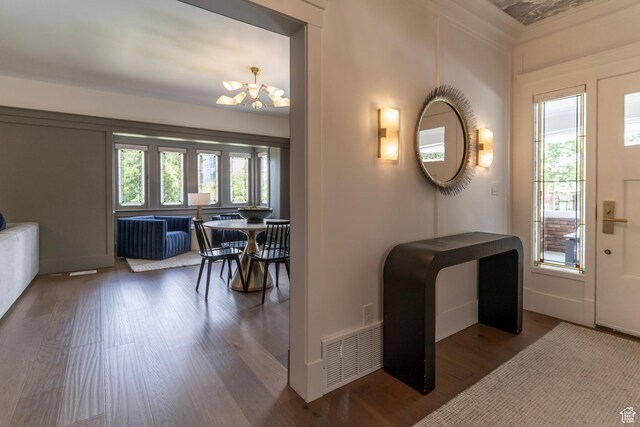 158 N State St, Salt Lake City, UT 84103 - entryway featuring wood finished floors, a chandelier, crown molding, and baseboards