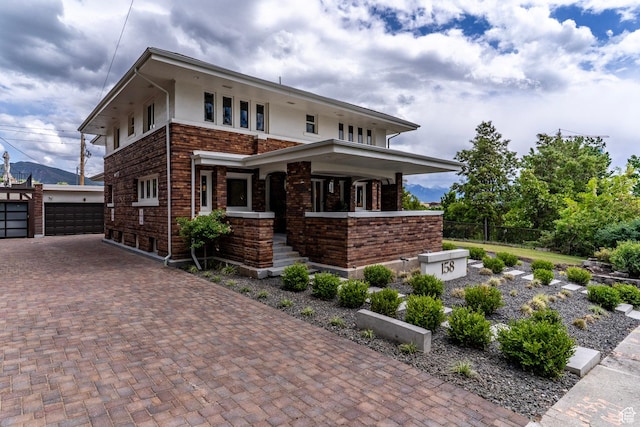 158 N State St, Salt Lake City, UT 84103 - view of front of property featuring an outdoor structure, brick siding, a garage, fence, and a porch