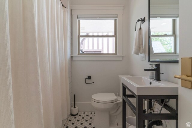 158 N State St, Salt Lake City, UT 84103 - bathroom featuring healthy amount of natural light, tile patterned floors, toilet, and a sink