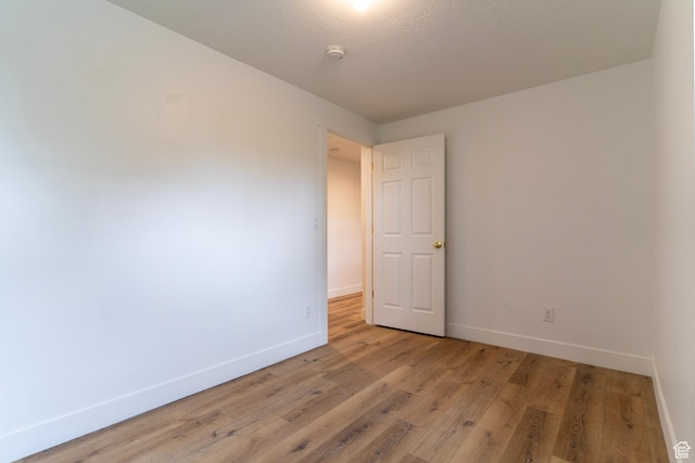 158 N State St, Salt Lake City, UT 84103 - empty room with baseboards, light wood finished floors, and a smoke detector