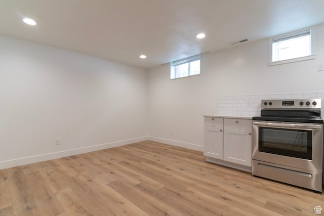 158 N State St, Salt Lake City, UT 84103 - kitchen with stainless steel electric stove, recessed lighting, white cabinets, light wood-type flooring, and light countertops