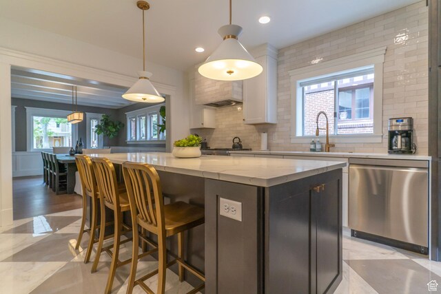 158 N State St, Salt Lake City, UT 84103 - kitchen featuring dishwasher, a kitchen island, tasteful backsplash, a breakfast bar, and recessed lighting