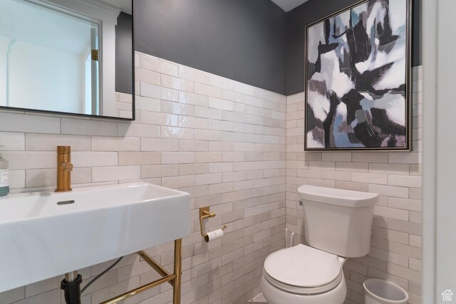 158 N State St, Salt Lake City, UT 84103 - half bathroom featuring tile walls, toilet, and a sink