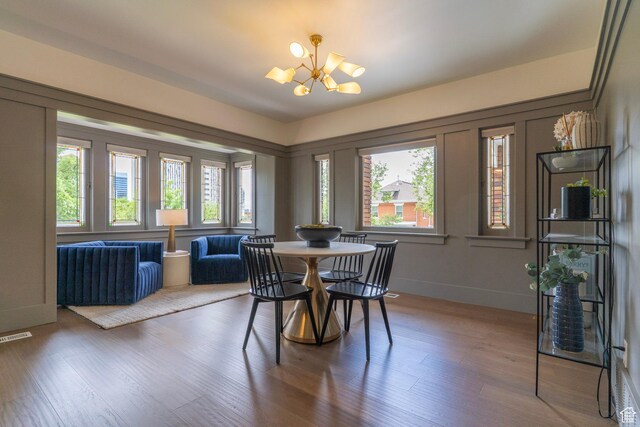 158 N State St, Salt Lake City, UT 84103 - dining area featuring a chandelier, wood finished floors, and baseboards