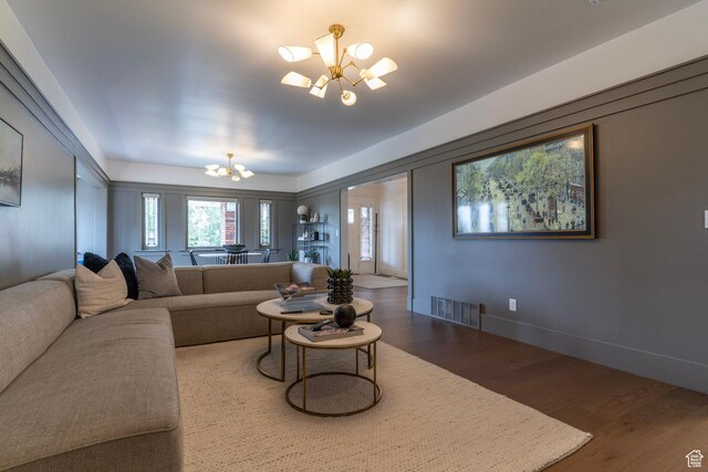 158 N State St, Salt Lake City, UT 84103 - living area with a chandelier, wood finished floors, and baseboards