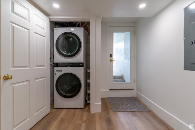 158 N State St, Salt Lake City, UT 84103 - laundry room with stacked washer and clothes dryer, light wood-style flooring, recessed lighting, baseboards, and electric panel