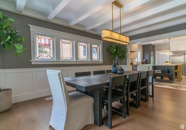 158 N State St, Salt Lake City, UT 84103 - dining space featuring beamed ceiling, hardwood / wood-style floors, wainscoting, and a decorative wall
