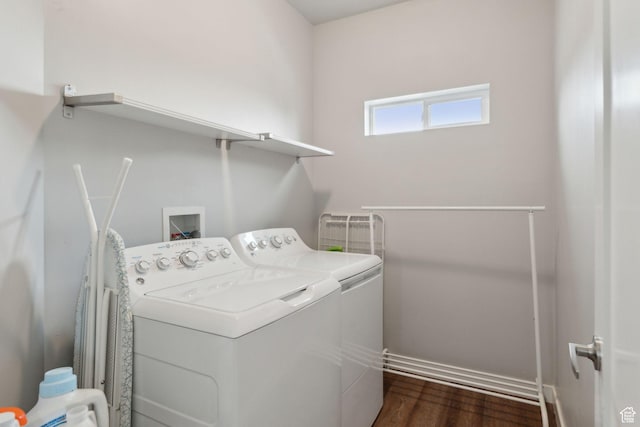 washroom featuring washing machine and dryer and dark wood-style flooring