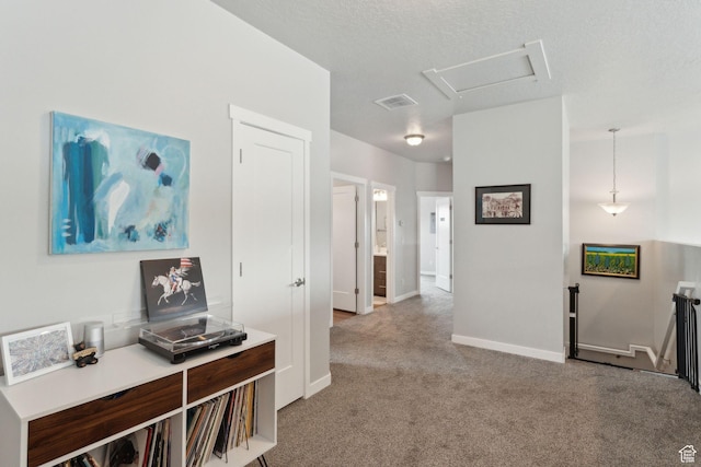 hallway featuring carpet flooring and baseboards