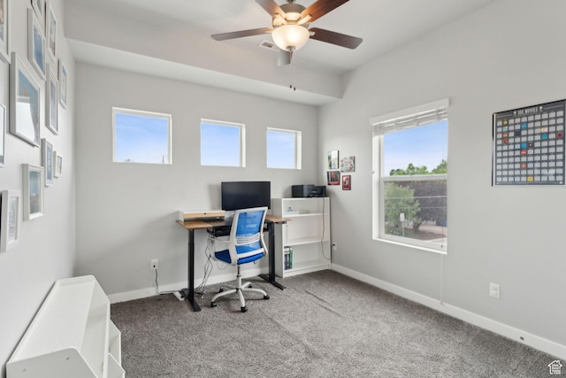 carpeted home office featuring a ceiling fan and baseboards