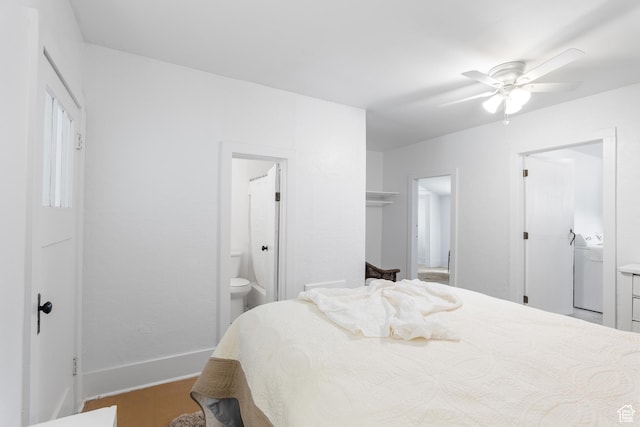 bedroom featuring washer / dryer, wood finished floors, connected bathroom, and baseboards