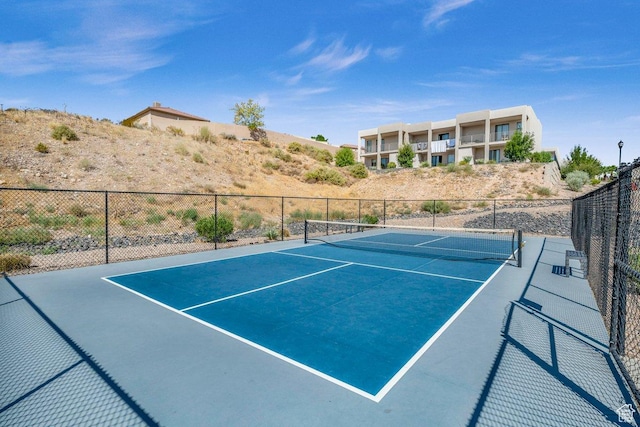 view of tennis court featuring fence