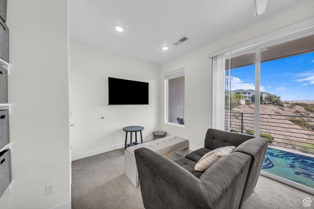 living area with carpet flooring, baseboards, and recessed lighting