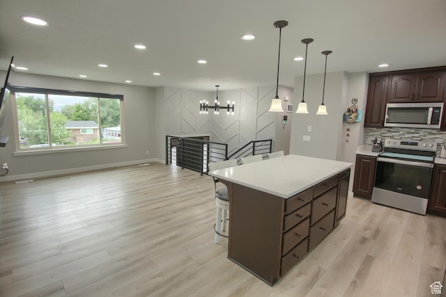 kitchen featuring stainless steel appliances, light wood-style flooring, light countertops, recessed lighting, and dark brown cabinetry