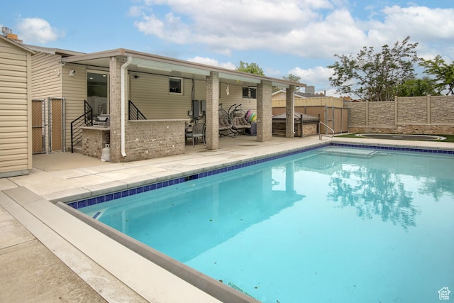 view of pool with a fenced backyard and a patio area