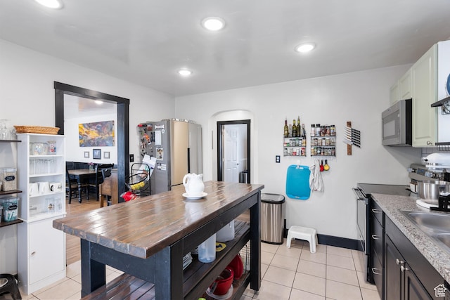 445 E Swenson Ave S, Springville, UT 84663 - kitchen with stainless steel appliances, light tile patterned flooring, baseboards, recessed lighting, and a sink