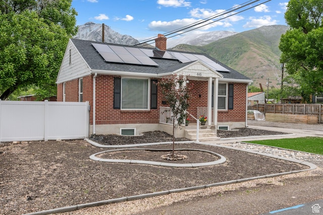 445 E Swenson Ave S, Springville, UT 84663 - bungalow-style house with brick siding, a chimney, a mountain view, and roof mounted solar panels