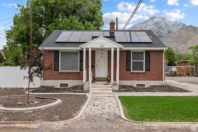 445 E Swenson Ave S, Springville, UT 84663 - view of front of home with brick siding, a chimney, roof with shingles, and solar panels