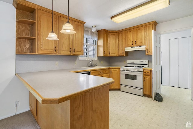 kitchen with white range with gas stovetop, under cabinet range hood, a sink, light countertops, and a peninsula