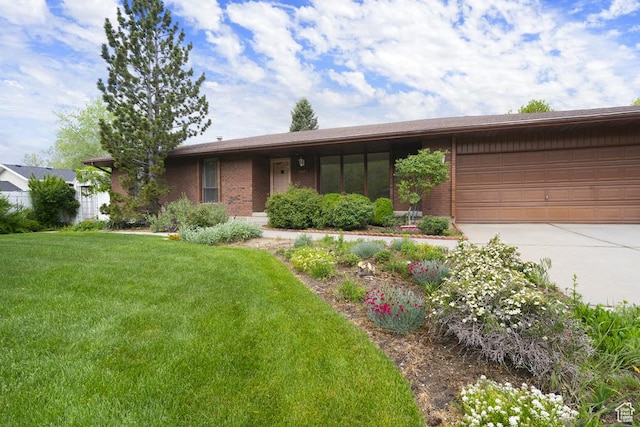 view of front of house featuring concrete driveway, a garage, brick siding, and a front yard