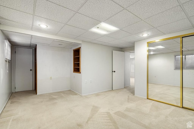 finished below grade area with carpet flooring, a paneled ceiling, and recessed lighting