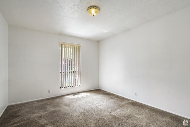 carpeted empty room with baseboards