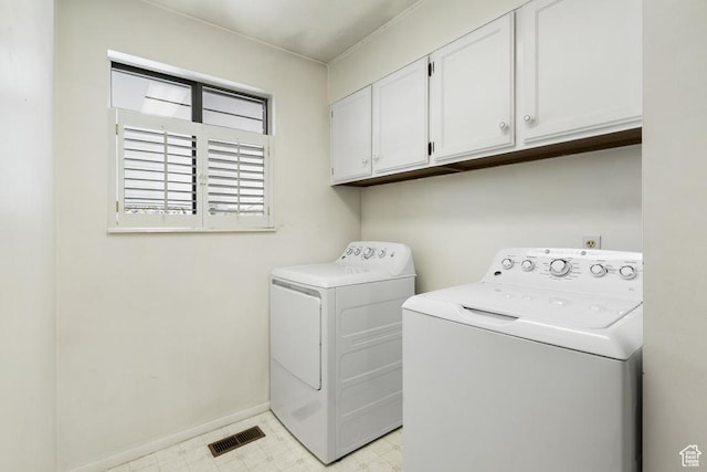 laundry room with washer and dryer, cabinet space, light flooring, and baseboards