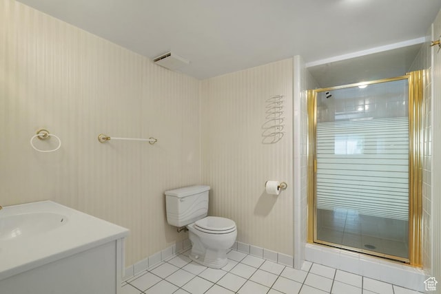 bathroom with tile patterned floors, a stall shower, toilet, baseboards, and vanity
