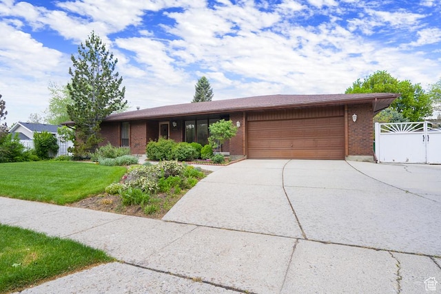 view of front of home featuring a garage, driveway, and brick siding
