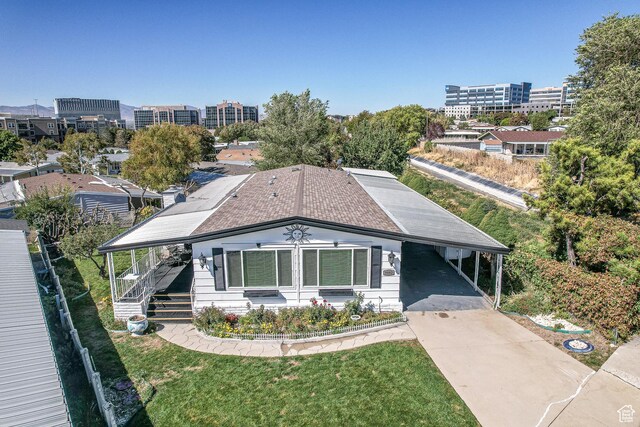 view of front facade with an attached carport, concrete driveway, and a porch